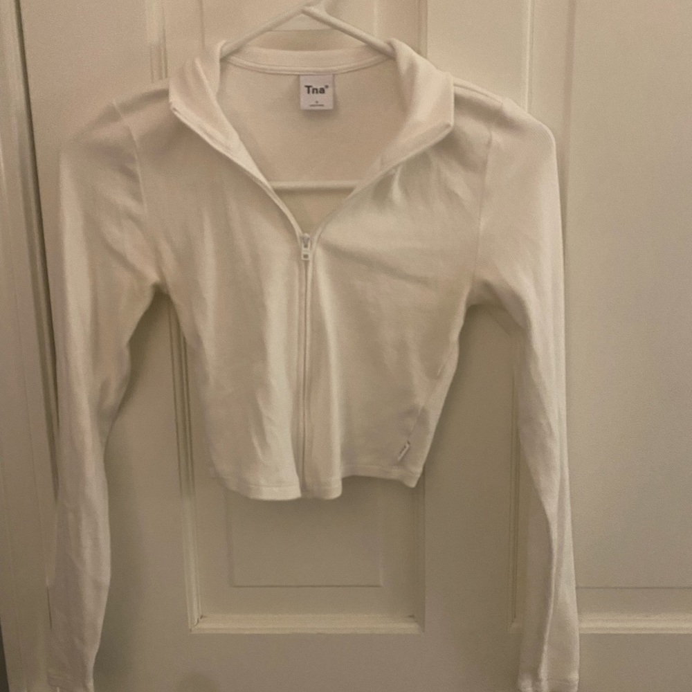 white cropped long-sleeve zip up shirt.